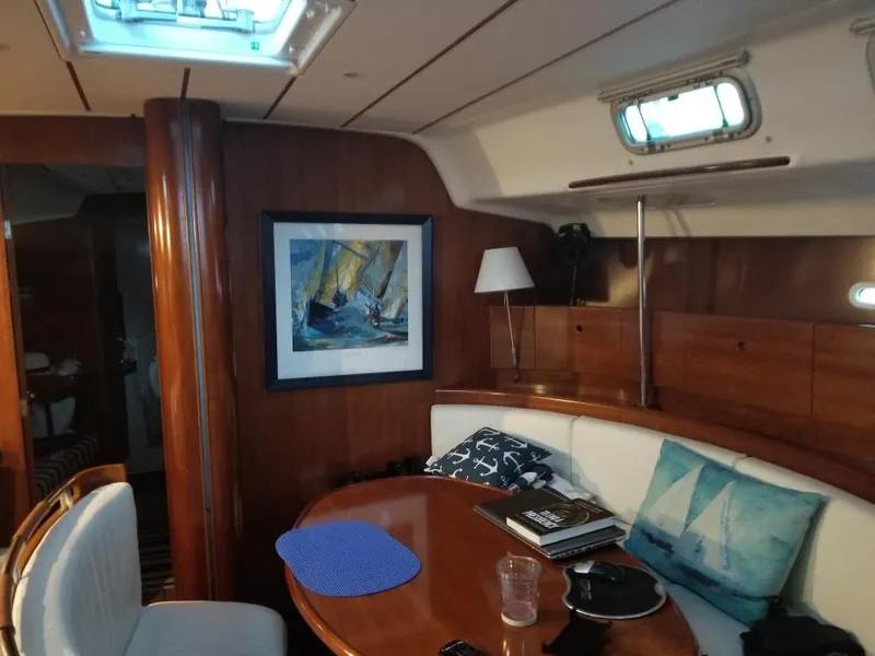 Slide: The Image of Interior of 2004 Beneteau First 47.7 yacht with cozy seating and nautical decor. - 22