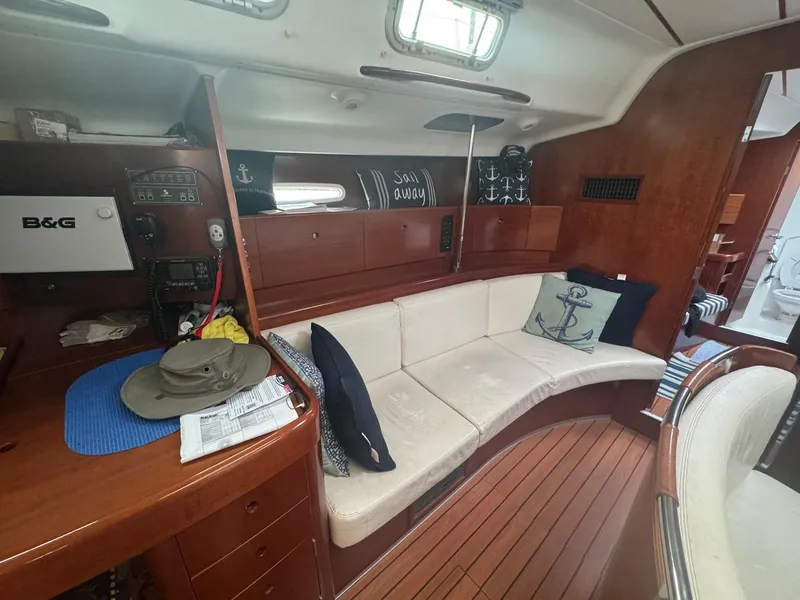 Slide: The Image of Interior of 2004 Beneteau First 47.7 yacht with cozy seating and nautical decor. - 23