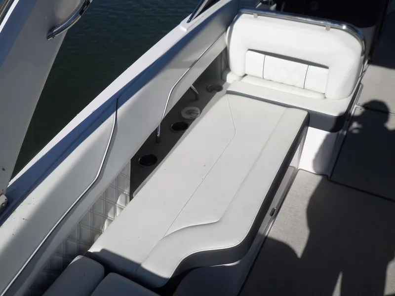 Slide: The Image of 2020 Regal LS6 boat interior with white seating and cup holders. - 13