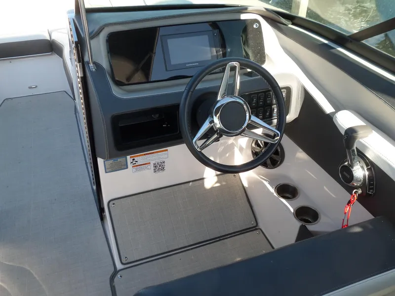 Slide: The Image of 2020 Regal LS6 boat cockpit with steering wheel and control panel. - 15