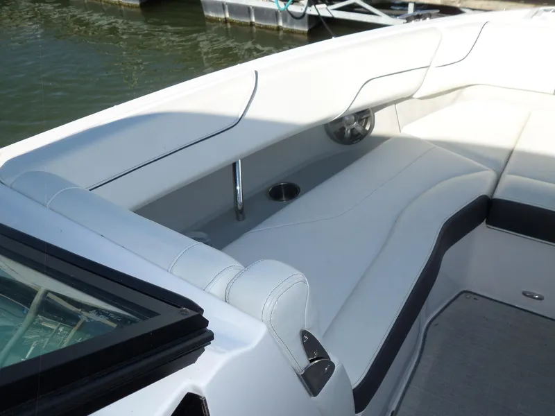 Slide: The Image of 2020 Regal LS6 boat interior with white seating and cup holder. - 17