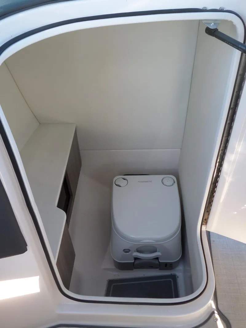 Slide: The Image of 2020 Regal LS6 boat interior with compact marine toilet. - 19
