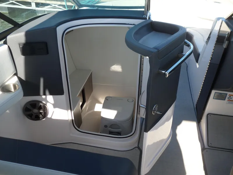 Slide: The Image of 2020 Regal LS6 boat interior with compact marine toilet and seating area. - 21