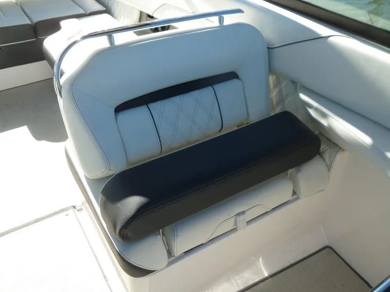 Slide: The Image of 2020 Regal LS6 boat seat with white and black upholstery, featuring diamond stitching. - 22