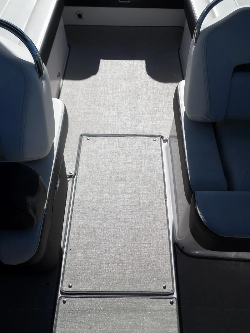 Slide: The Image of 2020 Regal LS6 boat interior with gray flooring and cushioned seating. - 24