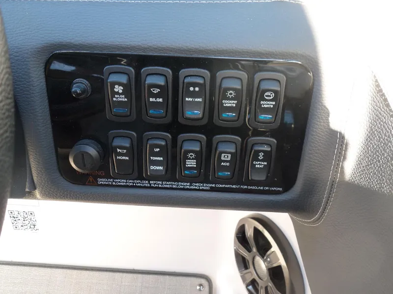 Slide: The Image of Control panel of a 2020 Regal LS6 boat with various switches and speaker. - 28