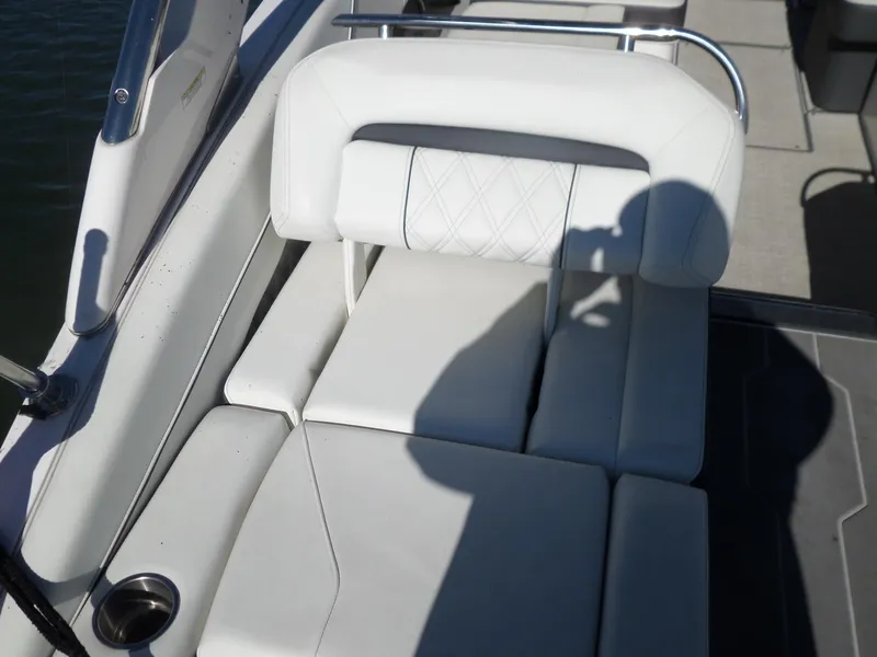 Slide: The Image of 2020 Regal LS6 boat interior with white leather seating and cup holder. - 34