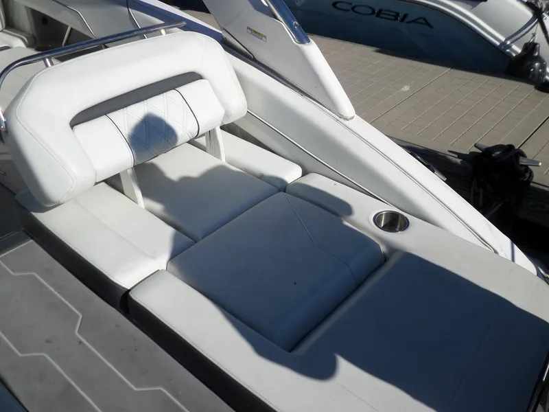 Slide: The Image of 2020 Regal LS6 boat with white leather seating and cup holder on deck. - 35