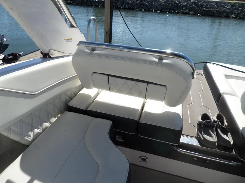Slide: The Image of 2020 Regal LS6 boat interior with white leather seating by the water. - 41