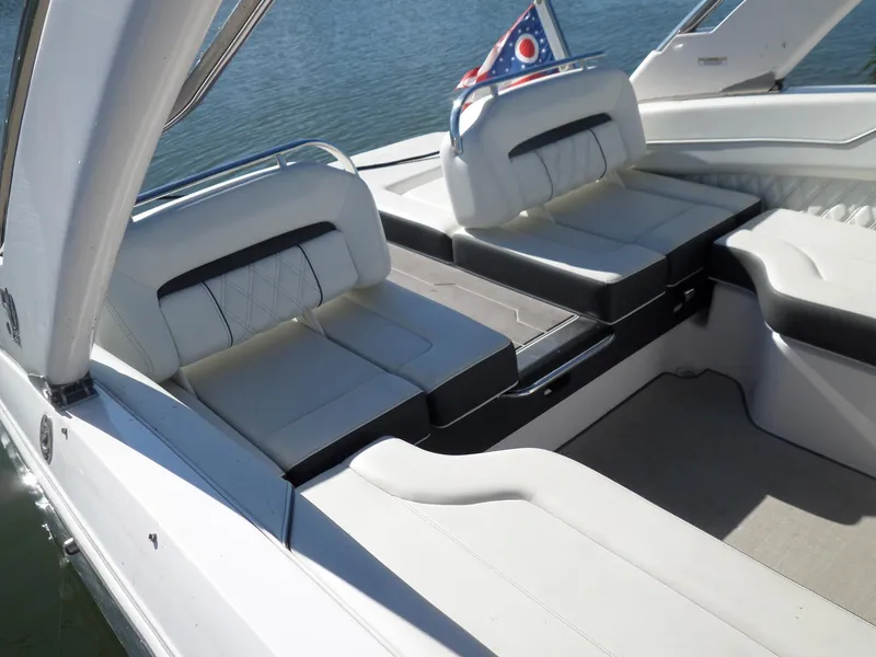 Slide: The Image of 2020 Regal LS6 boat interior with white leather seating and flag detail. - 6