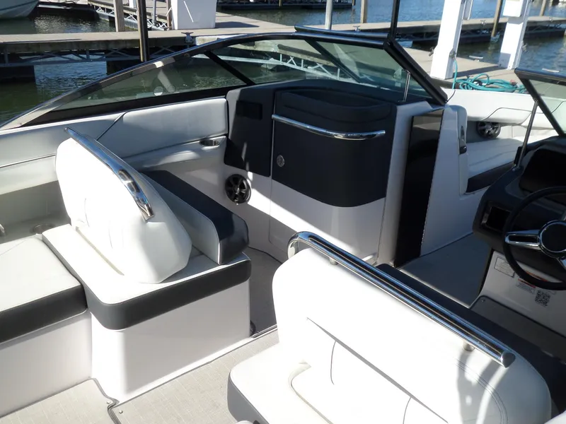 Slide: The Image of 2020 Regal LS6 boat interior with sleek seating and modern dashboard design. - 8