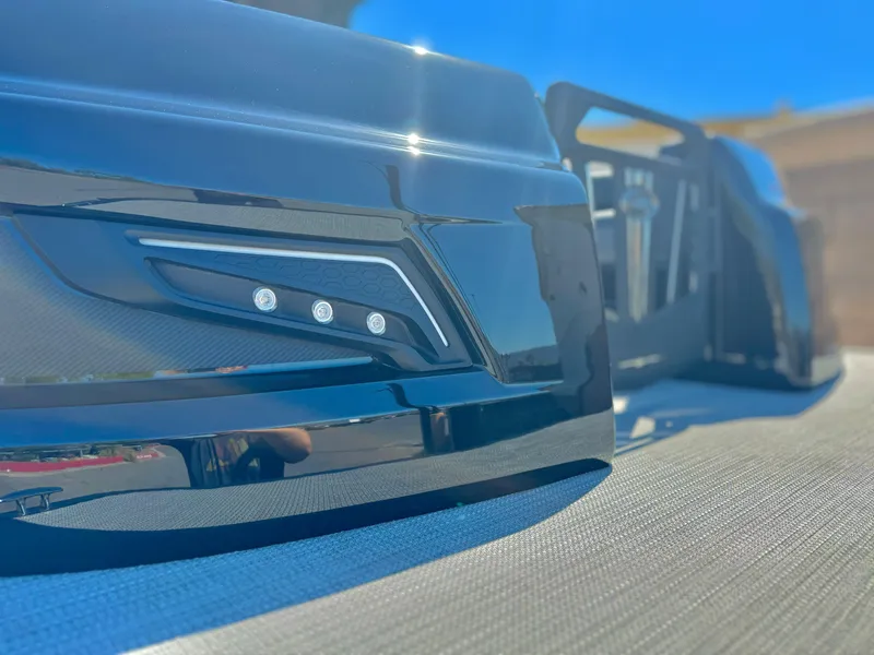 Slide: The Image of 2024 Manitou 23 XT RFXW close-up of sleek black exterior detail. - 10