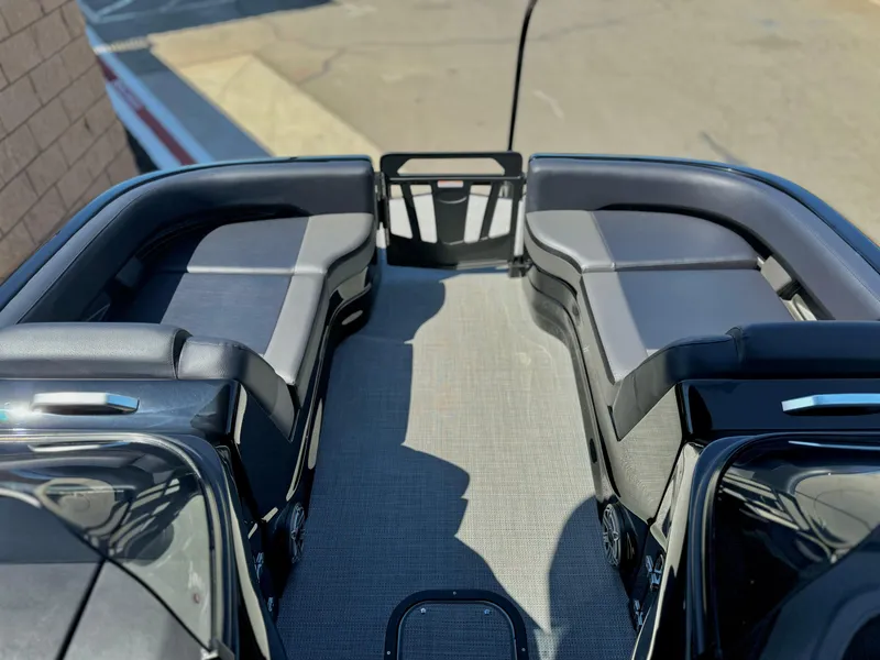 Slide: The Image of 2024 Manitou 23 XT RFXW boat interior with sleek seating and modern design. - 12