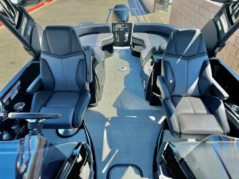 Slide: The Image of 2024 Manitou 23 XT RFXW boat interior with luxurious seating and modern design. - 14
