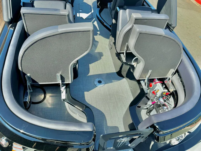 Slide: The Image of 2024 Manitou 23 XT RFXW boat interior with modern seating and sleek design. - 16