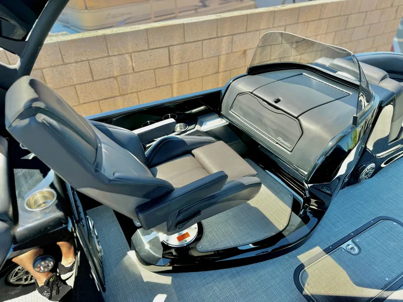 Slide: The Image of 2024 Manitou 23 XT RFXW boat interior with sleek seating and dashboard. - 20