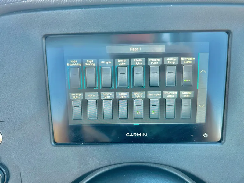 Slide: The Image of Garmin control panel in 2024 Manitou 23 XT RFXW boat, displaying various lighting and pump switches. - 23
