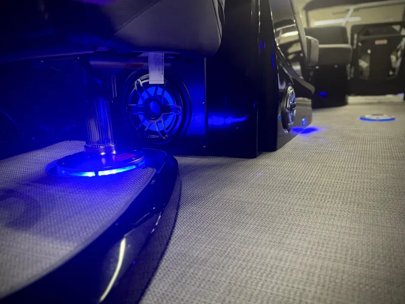 Slide: The Image of 2024 Manitou 23 XT RFXW interior with blue LED lighting and speaker system. - 27