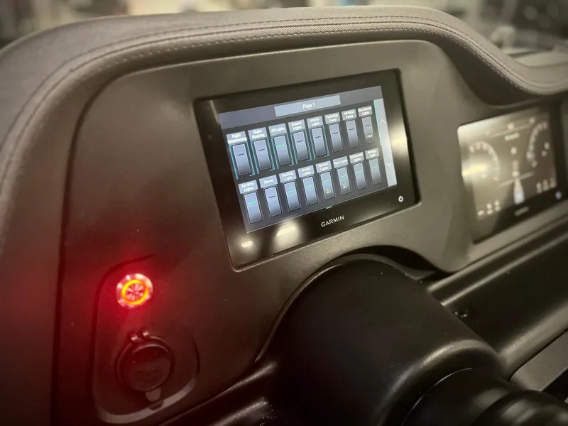 Slide: The Image of 2024 Manitou 23 XT RFXW dashboard with Garmin touchscreen display. - 30