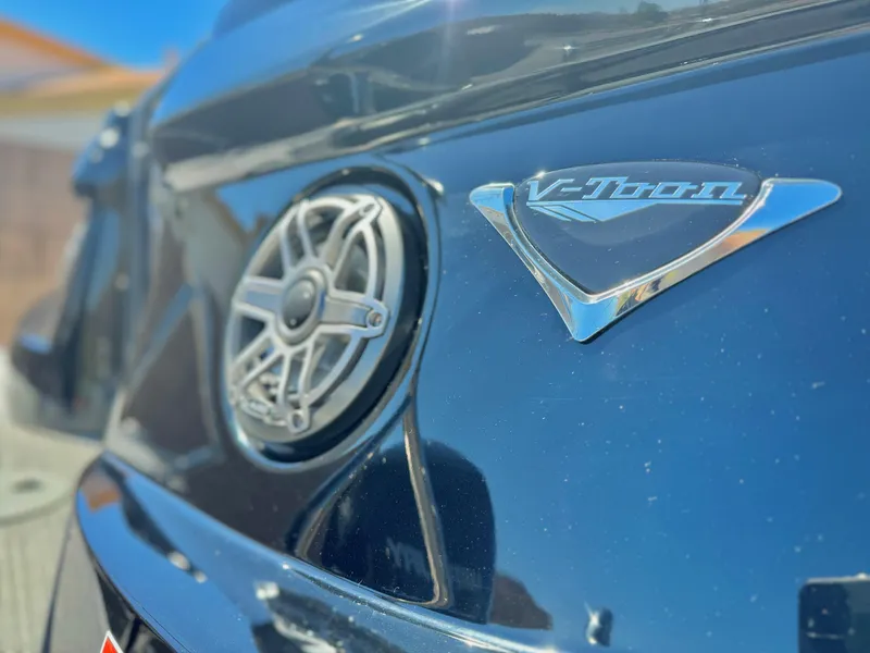 Slide: The Image of 2024 Manitou 23 XT RFXW boat detail with speaker and V-Toon logo. - 9