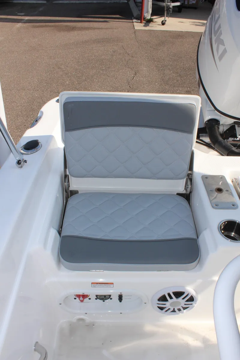 Slide: The Image of 2025 NauticStar 211 Hybrid boat seat with quilted design and cup holder. - 13