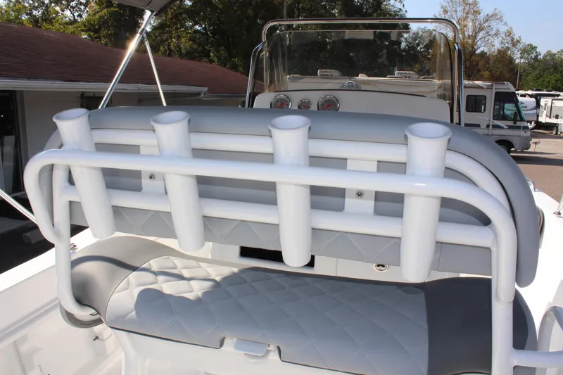 Slide: The Image of 2025 NauticStar 211 Hybrid boat with rod holders and cushioned seating. - 14