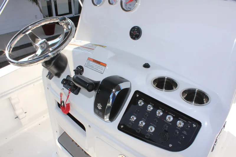 Slide: The Image of 2025 NauticStar 211 Hybrid boat console with steering wheel and control panel. - 16