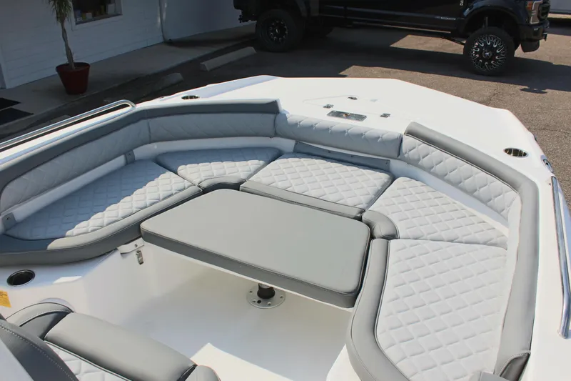 Slide: The Image of 2025 NauticStar 211 Hybrid boat interior with cushioned seating and table. - 20