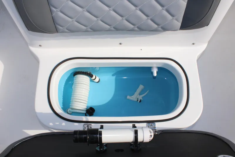 Slide: The Image of 2025 NauticStar 211 Hybrid boat livewell with hose and nozzle. - 29