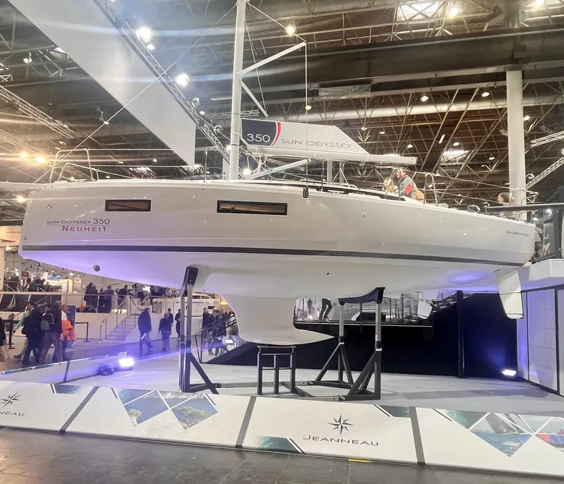 Slide: The Image of 2026 Jeanneau Sun Odyssey 350 sailboat displayed at an indoor boat show. - 11