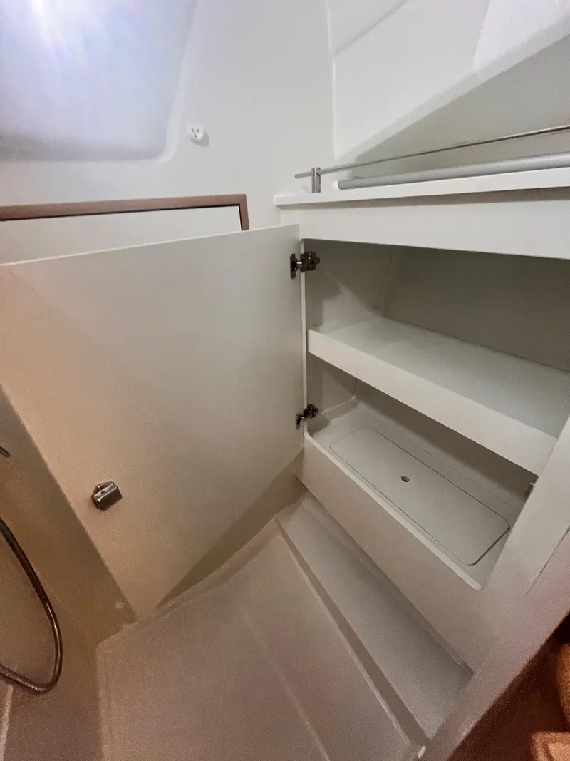 Slide: The Image of 2026 Jeanneau Sun Odyssey 350 yacht interior storage cabinet with open shelves. - 14