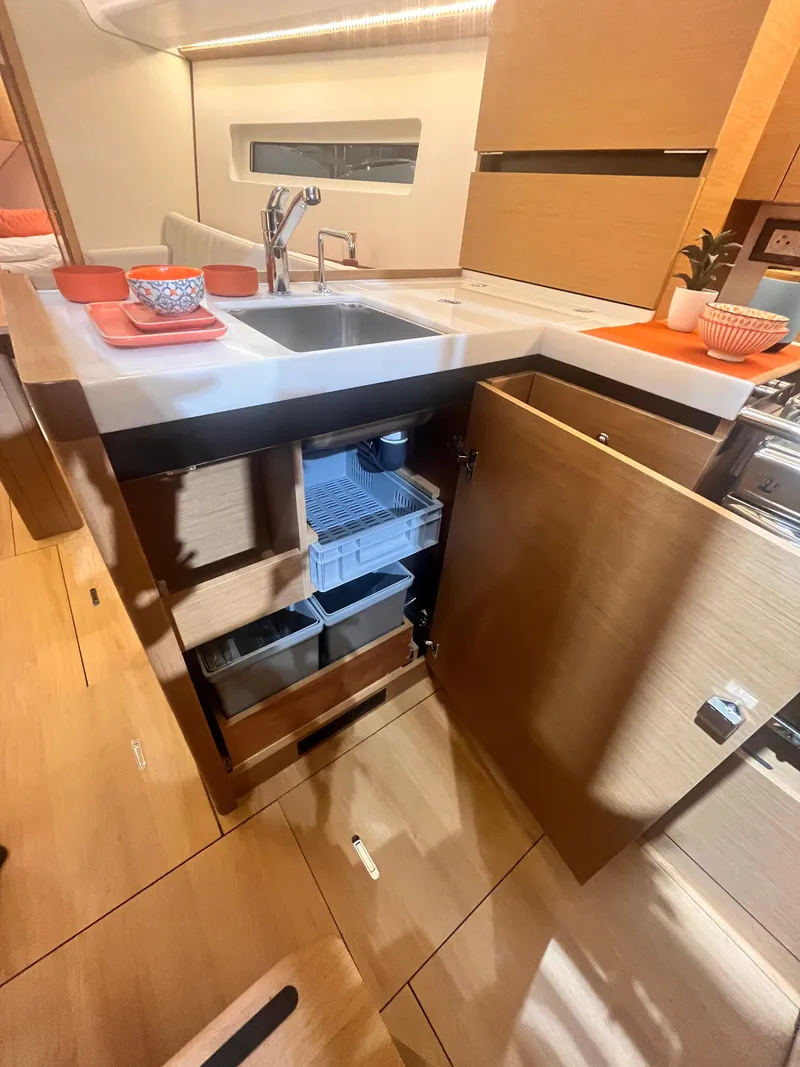 Slide: The Image of Modern kitchen interior of 2026 Jeanneau Sun Odyssey 350 yacht, featuring sleek cabinetry and sink. - 15