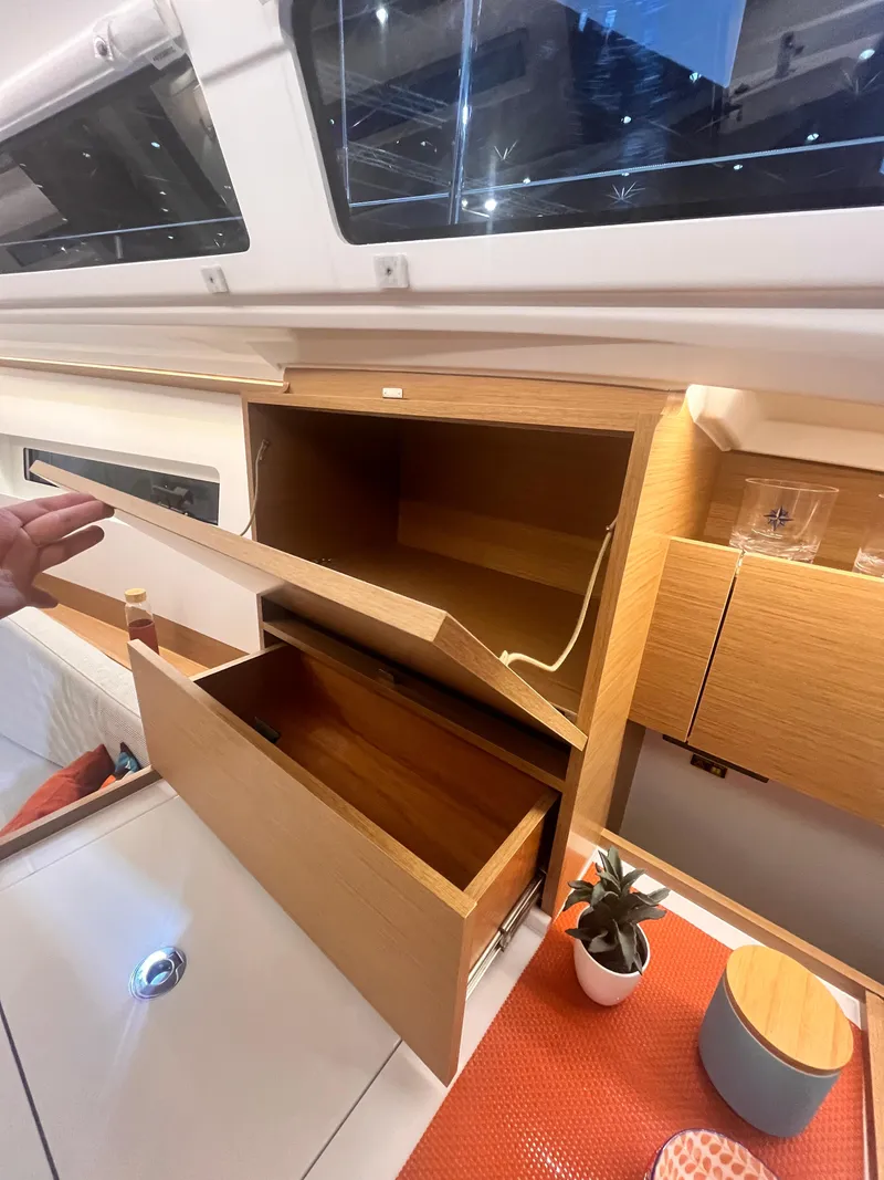 Slide: The Image of Interior of 2026 Jeanneau Sun Odyssey 350 yacht with open wooden cabinets. - 18