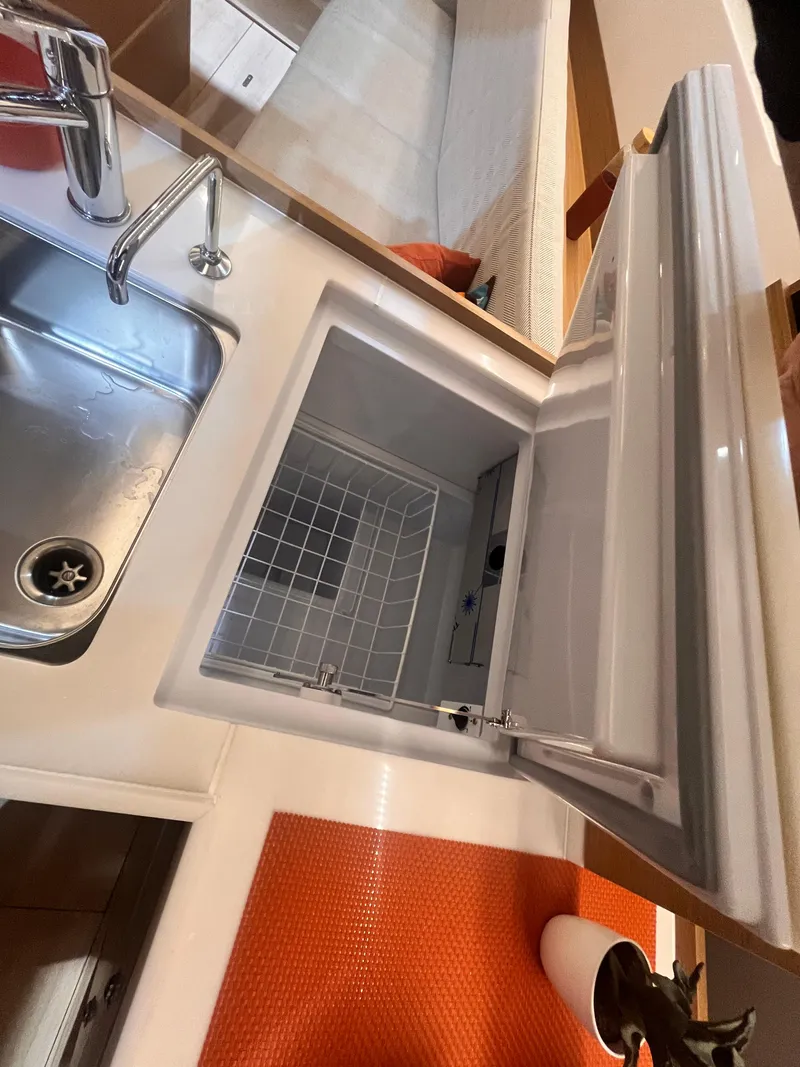Slide: The Image of 2026 Jeanneau Sun Odyssey 350 yacht kitchen with sink and open fridge. - 20