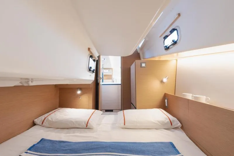 Slide: The Image of Interior cabin of Jeanneau Sun Odyssey 350-79373, 2026 model, featuring cozy bedding and modern design. - 23