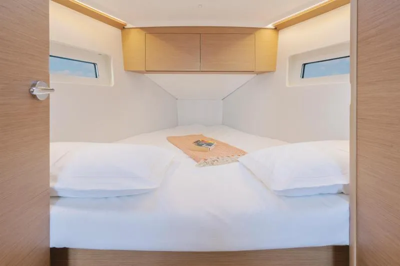 Slide: The Image of Cozy cabin interior of 2026 Jeanneau Sun Odyssey 350 yacht with double bed and windows. - 27
