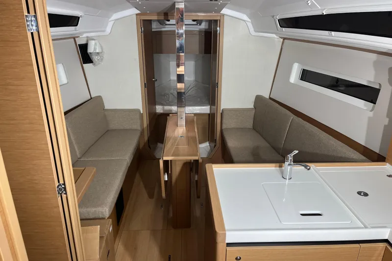Slide: The Image of Interior of 2026 Jeanneau Sun Odyssey 350 yacht, featuring modern seating and kitchenette. - 6