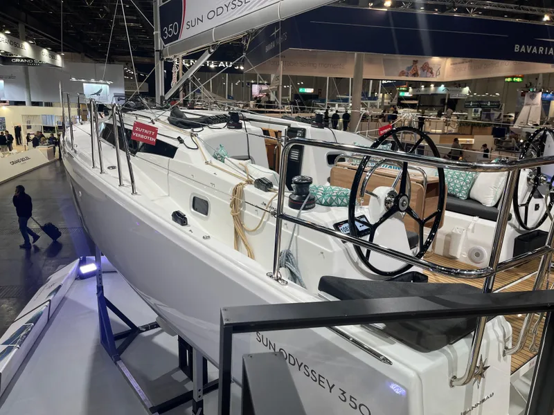 Slide: The Image of 2026 Jeanneau Sun Odyssey 350 sailboat displayed at an indoor boat show. - 8