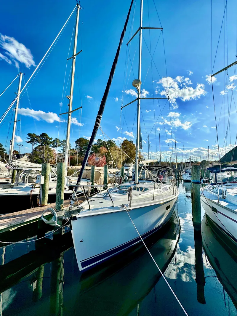 Slide: The Image of Sailboat docked in marina, Hunter 356, 2002 model, under clear blue sky. - 10