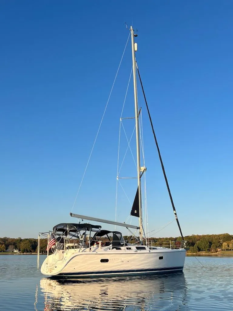 Slide: The Image of 2002 Hunter 356 sailboat on calm water under clear blue sky. - 11