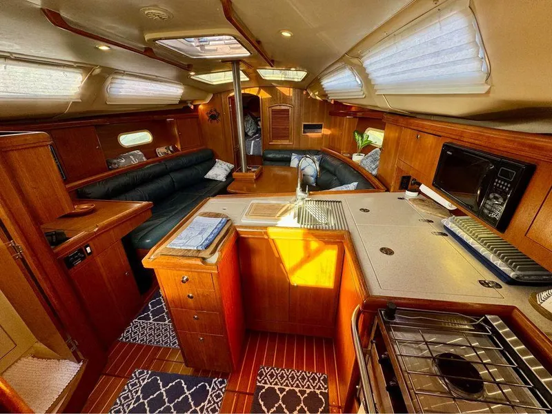 Slide: The Image of Luxurious 2002 Hunter 356 yacht interior with wood finish and modern amenities. - 20