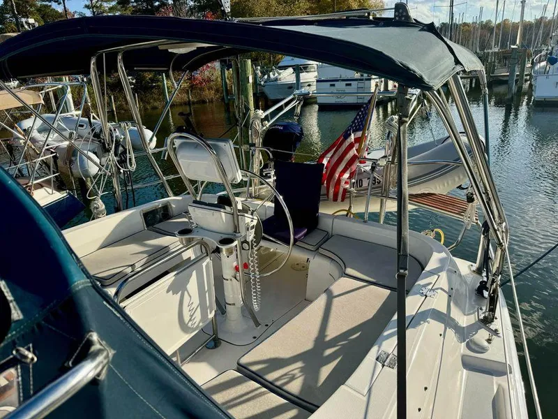 Slide: The Image of 2002 Hunter 356 sailboat with American flag, docked in marina. - 22