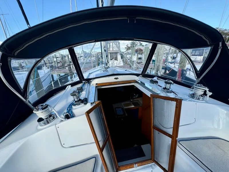 Slide: The Image of Interior view of 2002 Hunter 356 sailboat cockpit with open cabin doors. - 25