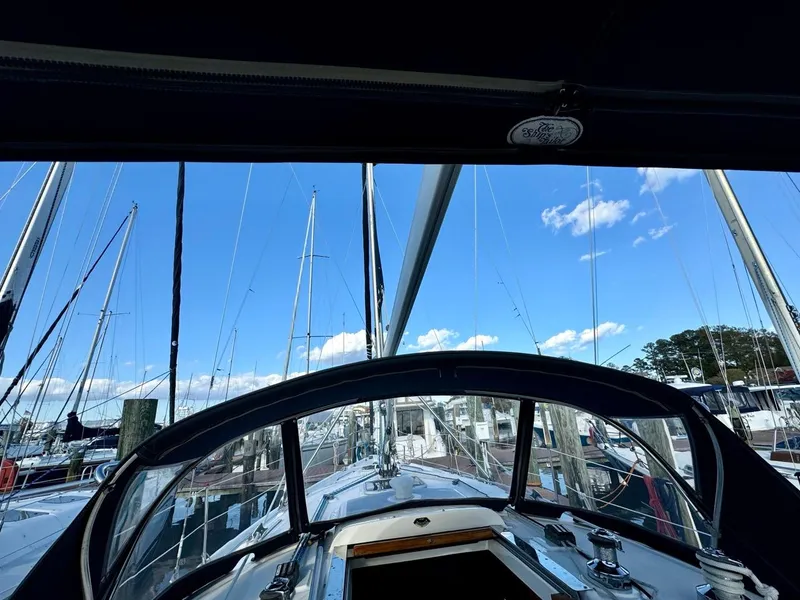 Slide: The Image of View from a 2002 Hunter 356 sailboat cockpit in a marina, clear blue sky. - 26