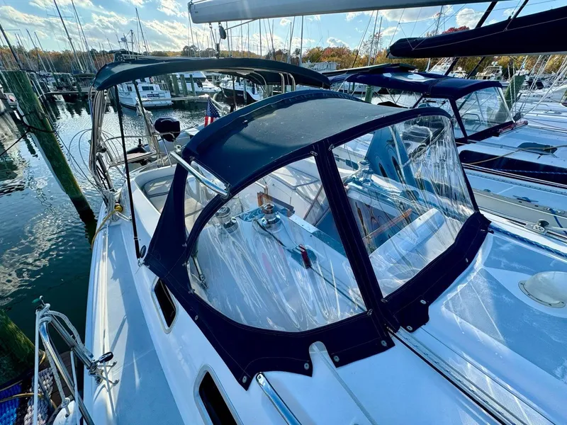 Slide: The Image of 2002 Hunter 356 sailboat with blue canopy docked at marina. - 27