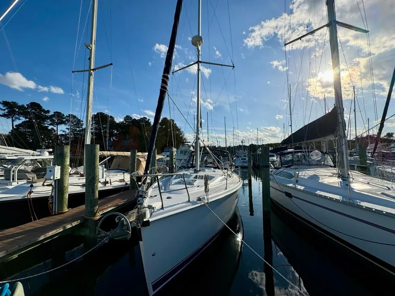 Slide: The Image of 2002 Hunter 356 sailboats docked at marina under clear blue sky. - 31