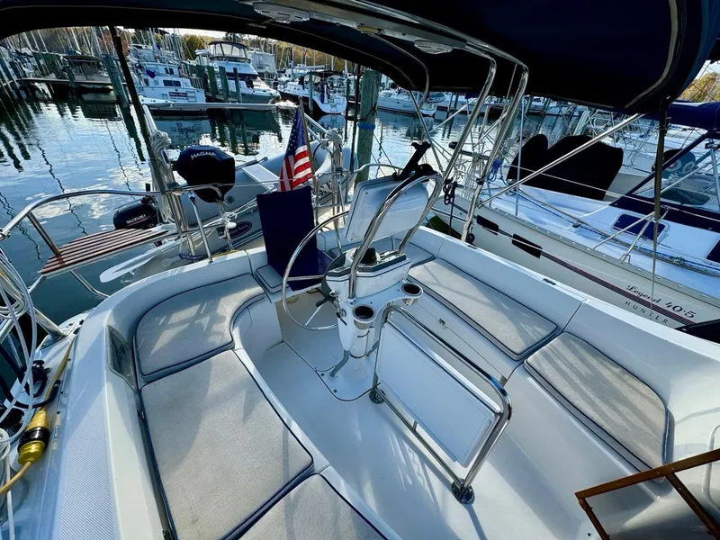 Slide: The Image of Hunter 356 sailboat cockpit, 2002 model, docked in marina with American flag. - 32