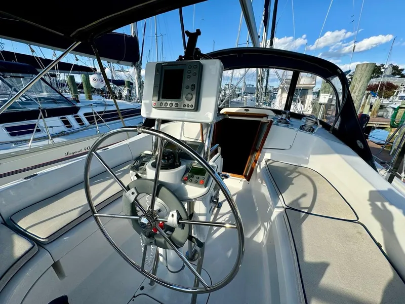Slide: The Image of 2002 Hunter 356 sailboat cockpit with steering wheel and navigation equipment. - 33