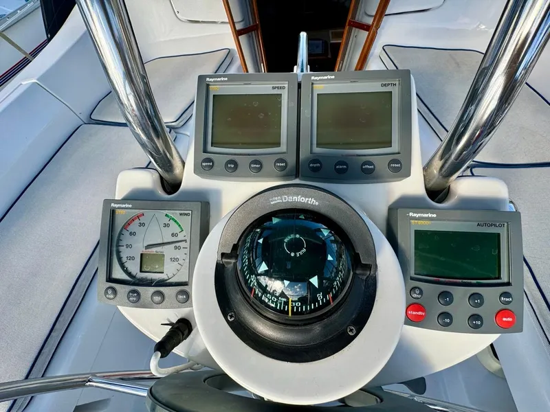 Slide: The Image of Sailboat cockpit with navigation instruments, compass, and gauges on a 2002 Hunter 356. - 34
