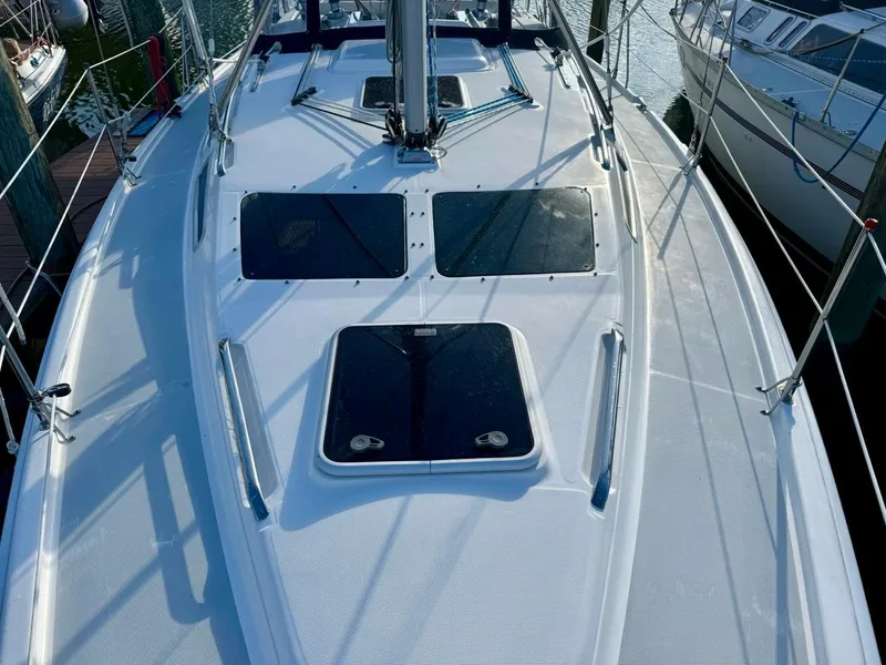 Slide: The Image of 2002 Hunter 356 sailboat deck with hatches and rigging in marina. - 37